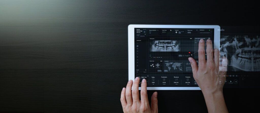 Dentist hands working with digital tablet to interact with VR , x - ray , patient teeth online treatment education study with AI on dark background.