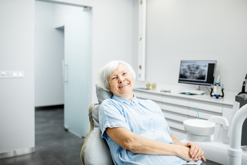 Smiling patient at a dental office after dental implant treatment