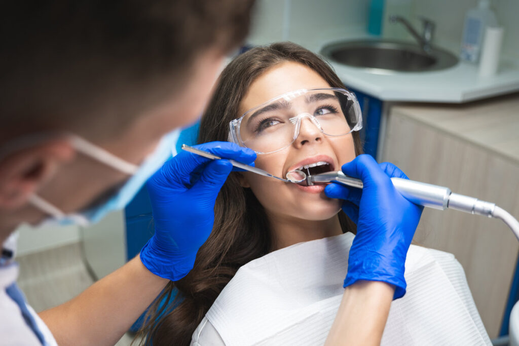 Dentist performing oral surgery procedure at Johns Creek Dental Associates