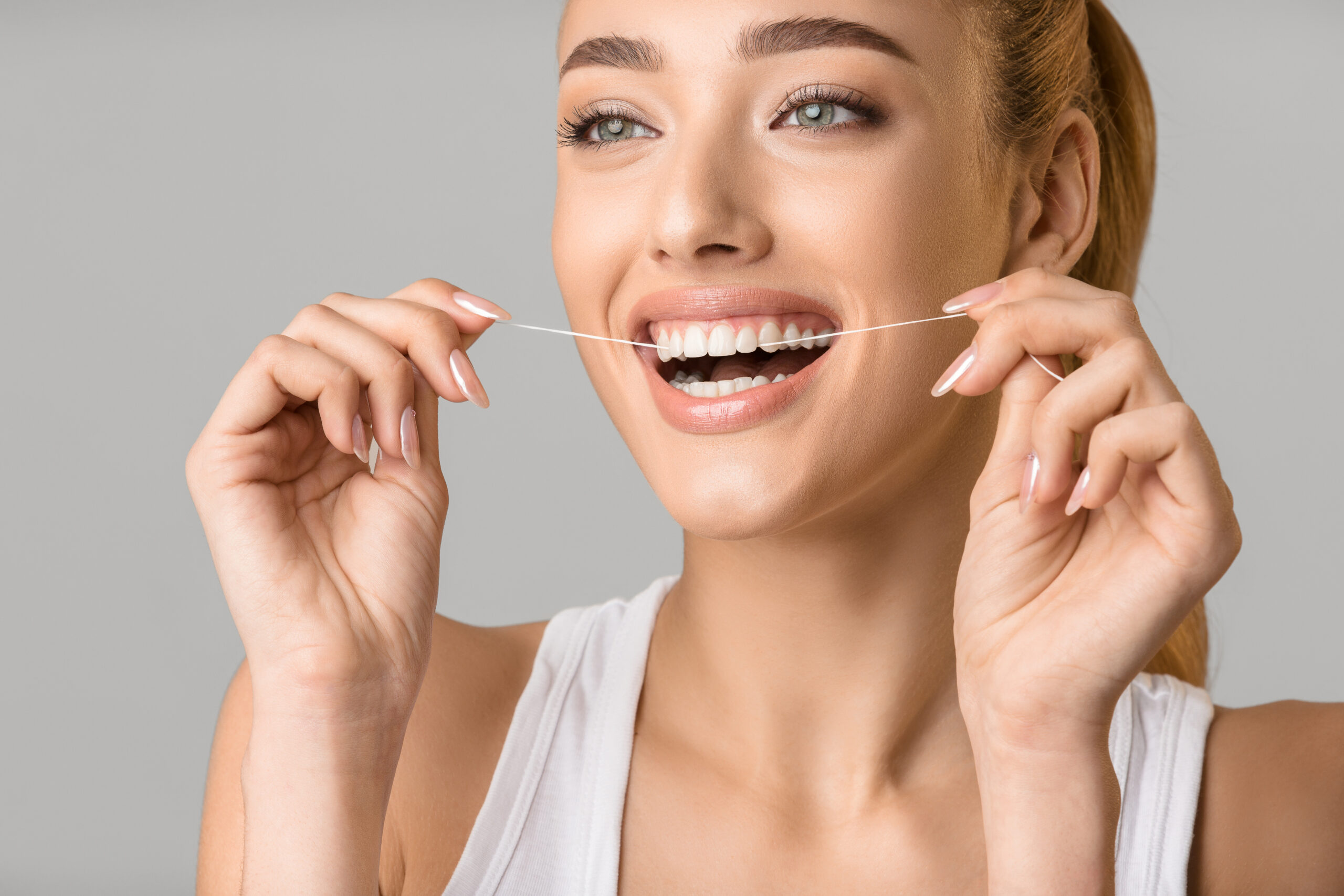 Woman smiling to show healthy white teeth after cosmetic dental treatment